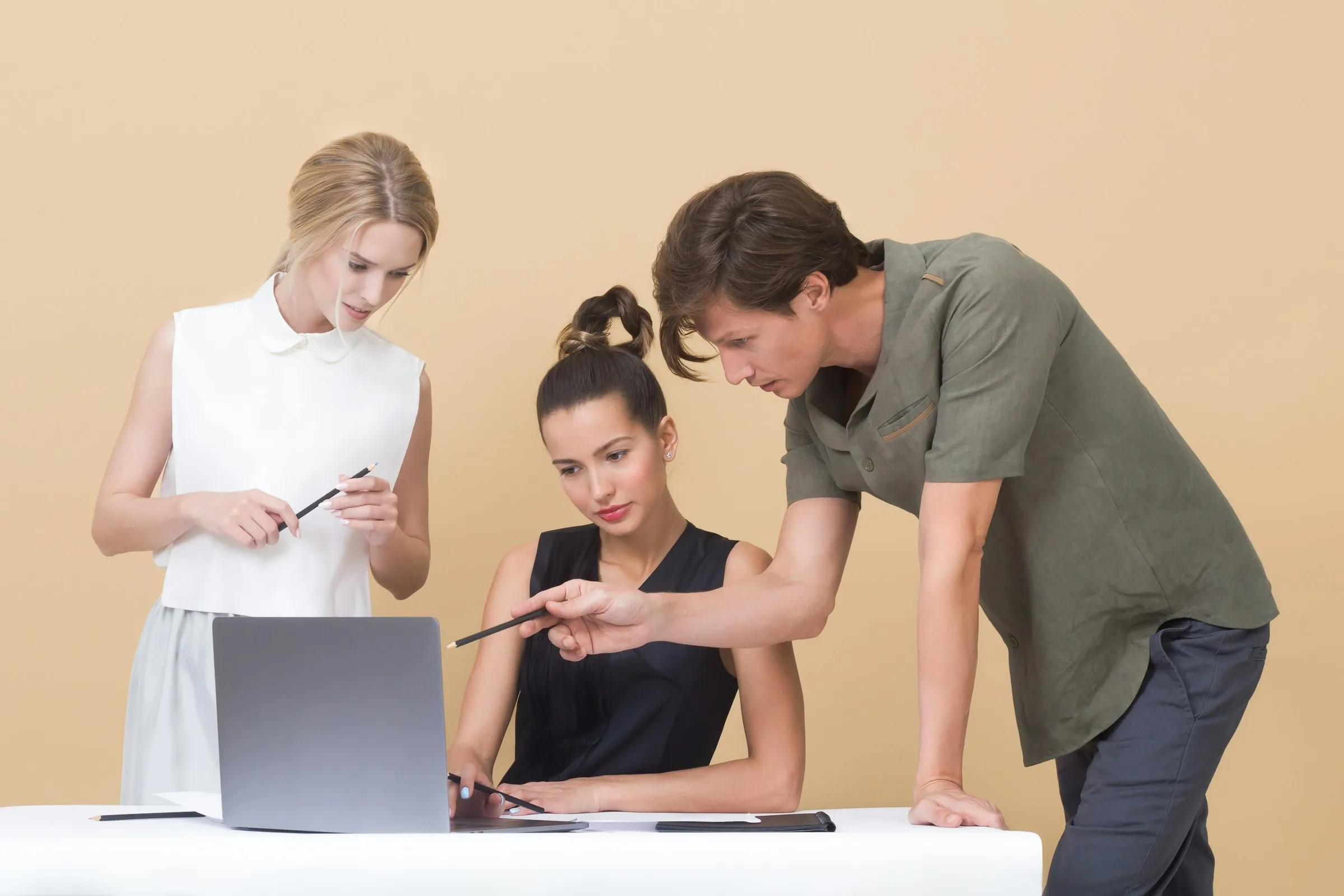 Two people working through something on a laptop